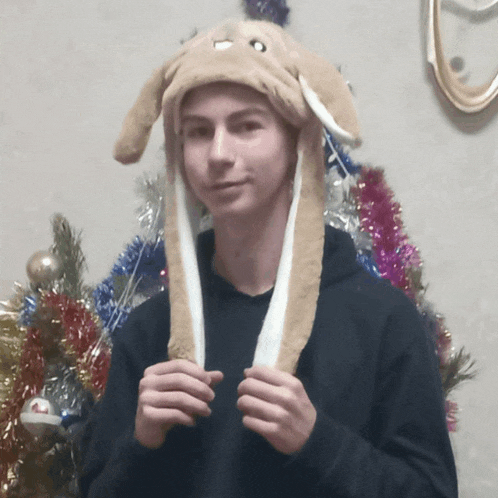a young man wearing a hat with bunny ears