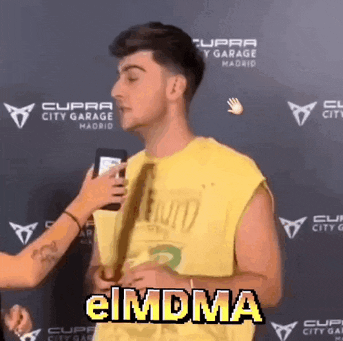 a man in a yellow shirt is being interviewed by a woman and the word eimdma is on the bottom