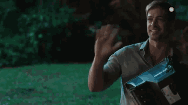 a man is holding a box in his hands and smiling