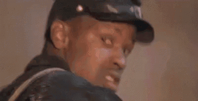 a man in a baseball cap is making a funny face with his mouth open .