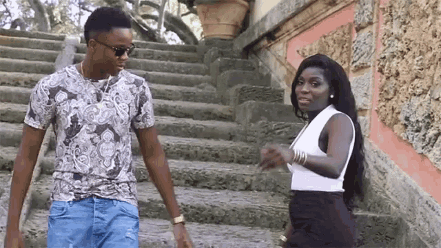 a man and a woman are walking down stairs together