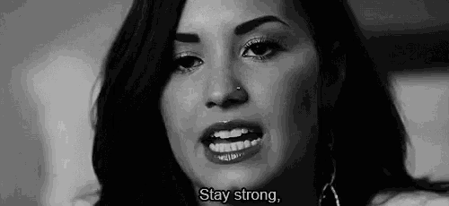 a black and white photo of a woman with the words `` stay strong '' written below her .
