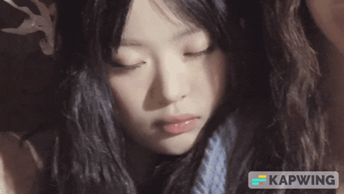 a close up of a woman 's face with the word kapwing on the bottom right
