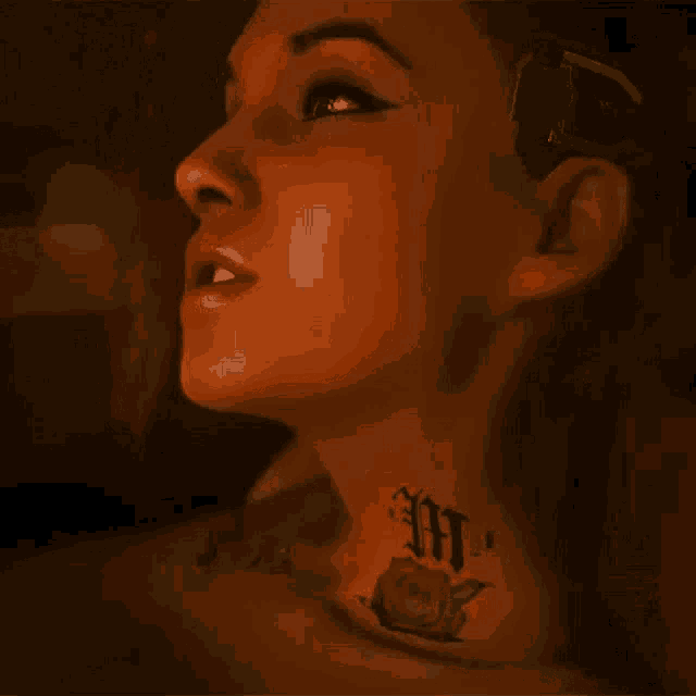 a woman has a tattoo on her neck that says ' mj '