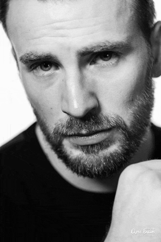 a black and white photo of a man with the name chris evans on the bottom right