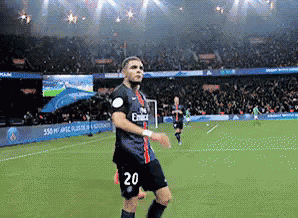 a soccer player wearing a fly emirates jersey is running on the field