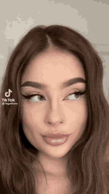 a close up of a woman 's face with a tik tok sticker on it