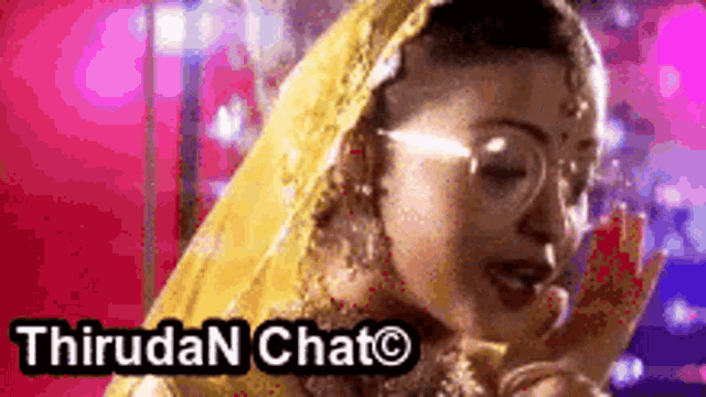 a woman wearing a yellow veil and glasses is talking on a cell phone with the words thirudan chat on the bottom