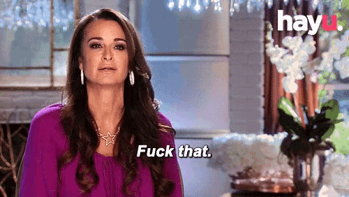 a woman in a purple shirt is saying fuck that