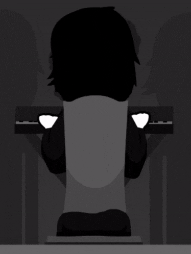a silhouette of a person sitting at a keyboard