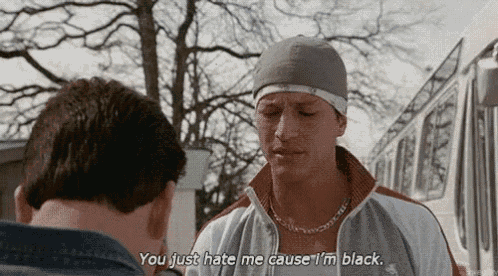 two men are standing next to each other and one of them is saying `` you just hate me cause i 'm black . ''