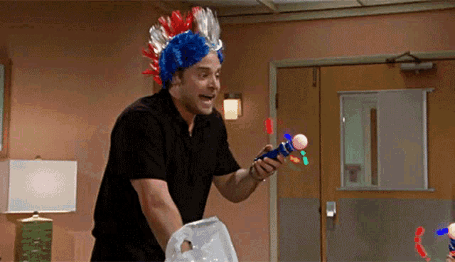 a man wearing a red white and blue wig holds a toy