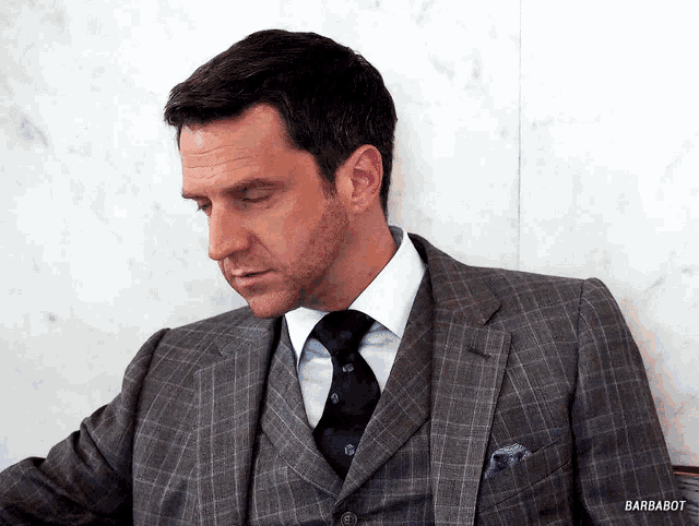 a man in a suit and tie with barbabot written on the bottom right