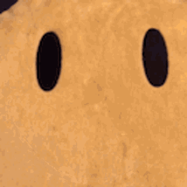 a yellow smiley face with black eyes and a black mouth