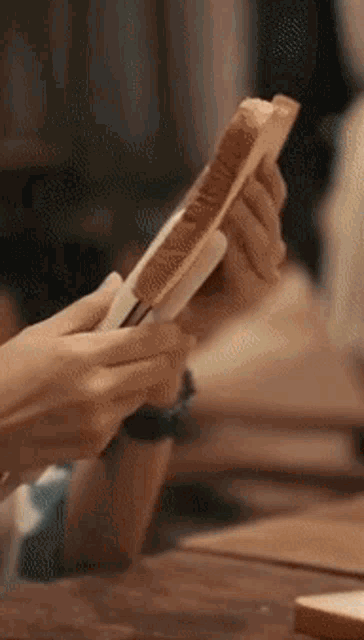 a person is holding a piece of toast in their hand .