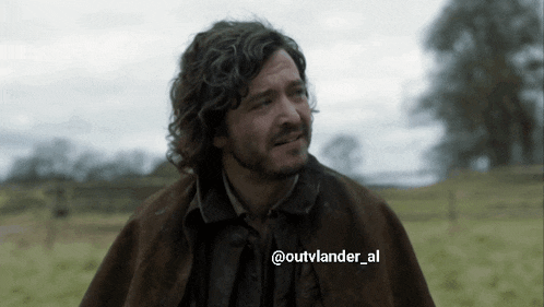 a man in a field with the hashtag outvlander al