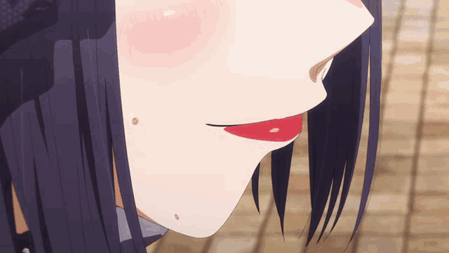 a close up of a girl 's face with red lipstick