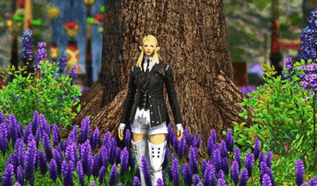 a woman is standing in a field of purple flowers .