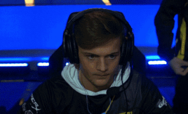 a man wearing headphones and a shirt that says ' gdp ' on it