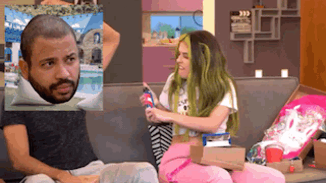 a man and a woman are sitting on a couch with a picture of a man 's head on a pillow
