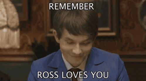 a man in a blue suit and tie is smiling with the caption remember ross loves you