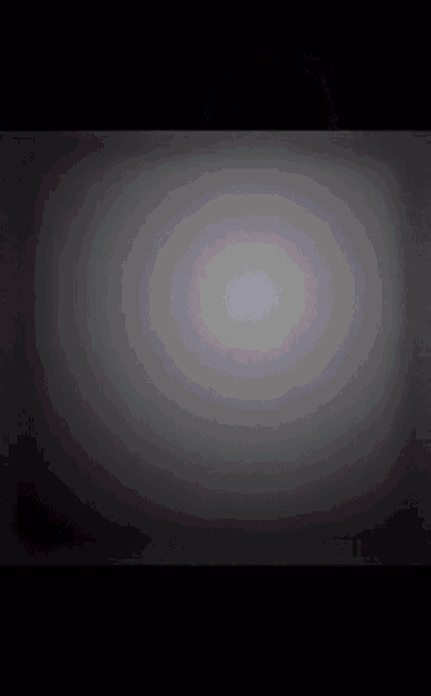 a black background with a gray gradient in the middle of it .