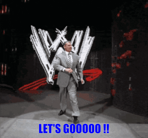a man in a suit and tie is standing in front of a w logo and says let 's gooooo !!