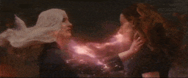 a woman is holding another woman 's hand in a bathtub .