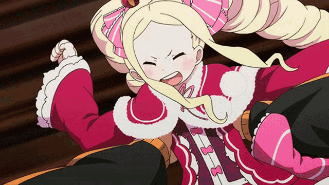 a girl with blonde hair and a pink bow on her head