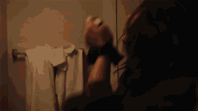 a woman is looking at herself in a bathroom mirror