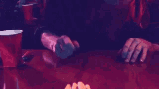 a person is playing a game with dice on a table .