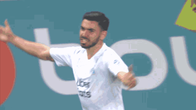 a soccer player wearing an uber eats shirt celebrates