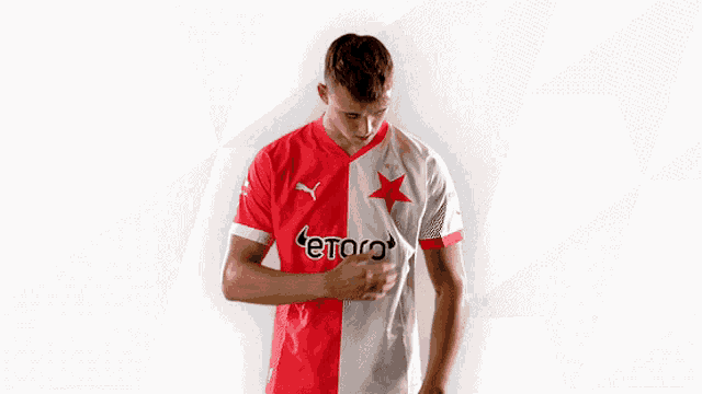 a man wearing a red and white jersey with etoro on it