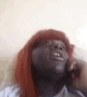 a close up of a person talking on a cell phone .