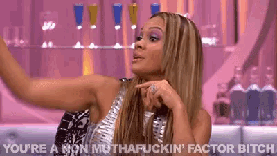 a woman is making a funny face and says " you 're a non muthafuckin ' factor bitch " .