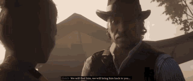 a man in a cowboy hat is talking to a woman in front of a building
