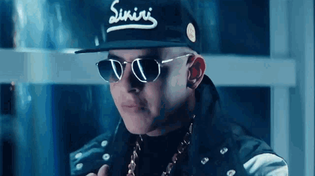 a man wearing sunglasses and a hat that says ' sumire ' on it