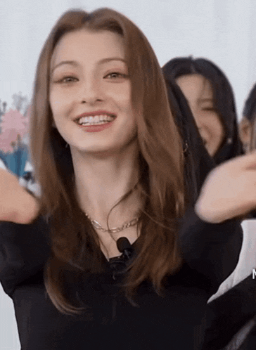 a woman with braces on her teeth is wearing a black top