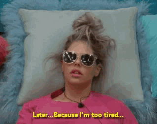 a woman wearing sunglasses is laying on a pillow and says " later because i 'm too tired " in yellow