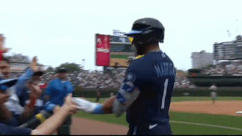 a baseball player wearing a number 1 jersey is being congratulated by his teammates