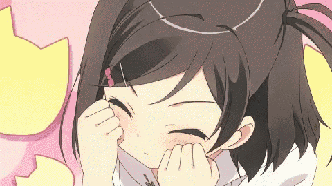 a girl with a cat ear on her head is rubbing her face .