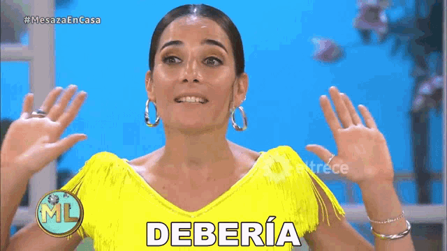 a woman in a yellow fringed top says deberia