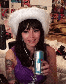 a woman wearing a white cowboy hat holds a can of diet coke