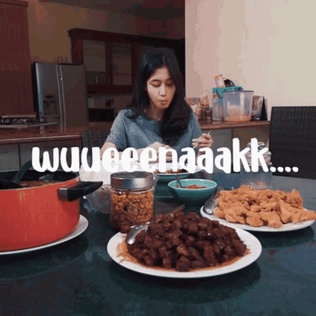 a woman is sitting at a table with plates of food and the words wuweenaaakk