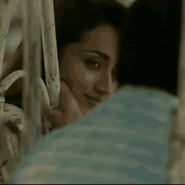 a woman looks at herself in the mirror and smiles