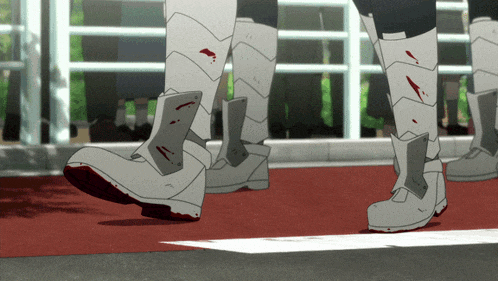 a person wearing a pair of white boots with blood on the bottom