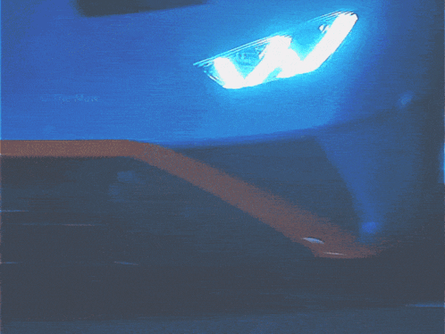 a close up of a car 's headlight with the caption " the maw " below it