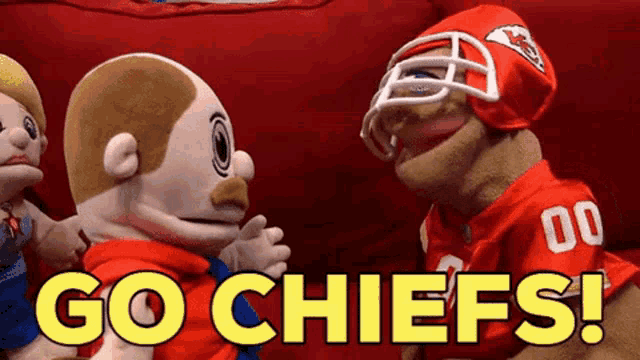 a puppet wearing a kansas city chiefs jersey says " go chiefs "