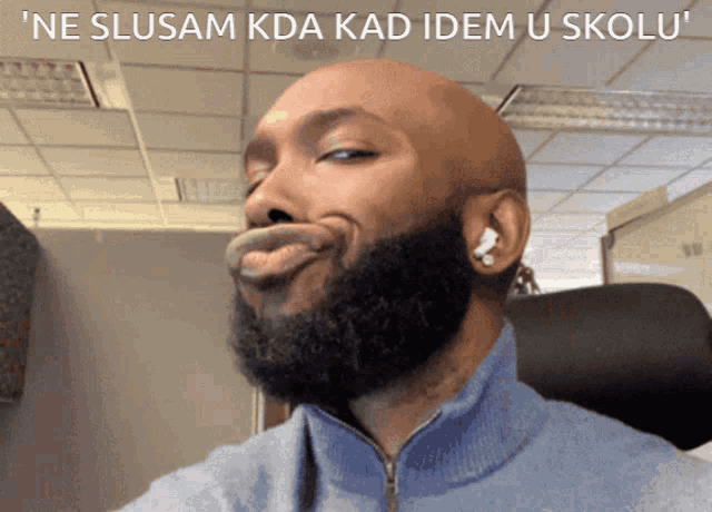 a man with a beard is making a funny face with the caption " ne slusam kda kad idem u skolu