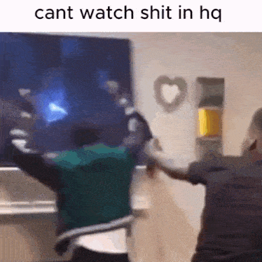 two people are dancing in front of a television with the words cant watch shit in hq written on the bottom .